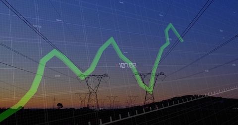 Electricity pylons at dusk with green line chart