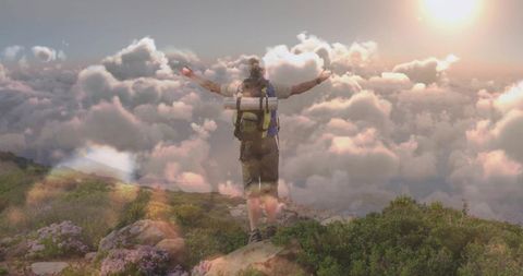 Hiker Embracing Highest Peak at Sunrise