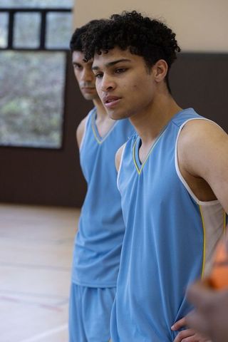 Young Basketball Teammates in Blue Jerseys Focus Before Game