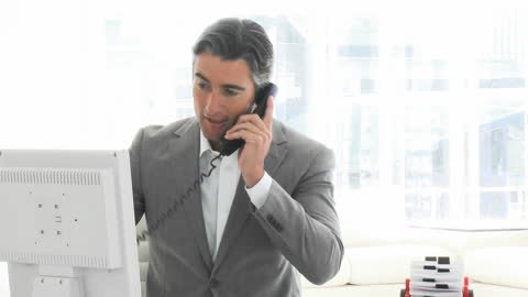 Business Professional Engaged in Phone Call at Modern Office