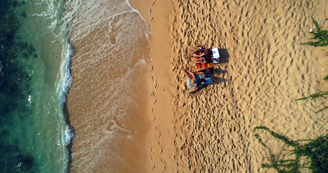 Aerial View of Friends Relaxing on Tropical Beach - Download Free Stock Images Pikwizard.com