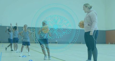 Coach coaching youth basketball drills in school gym holding ball with ai tech overlay and cones