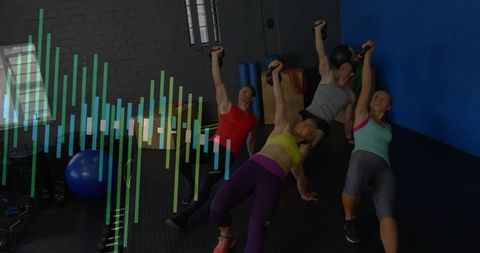 Group performing side-plank holding kettlebells strengthening core in gym class for functional fitne
