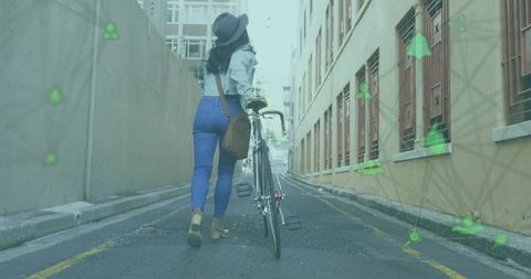 Asian woman walking and pushing bicycle through urban alley with augmented reality overlays