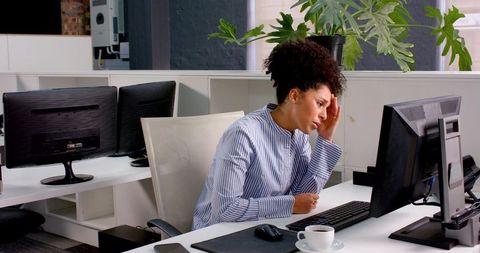 Stressed Businesswoman Rubbing Temples at Desk for Headache Relief - Download Free Stock Images Pikwizard.com