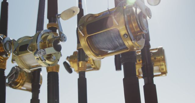 Close up detail of fishing rods standing up on a boat, ready to by used, on a sunny day, in slow motion