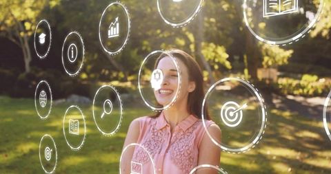 Young woman interacting with augmented reality ui in sunlit park, smiling tech lifestyle