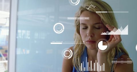 Businesswoman experiencing stress with overlaid data graphics