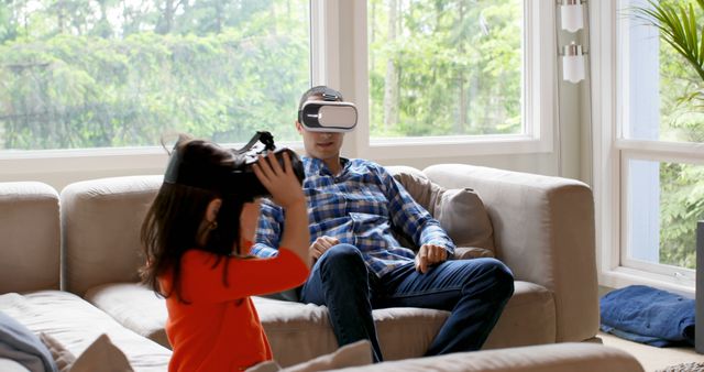 Perfect for depicting modern family activities involving technology. Useful for articles or advertisements related to virtual reality, family entertainment, and technology in daily life.