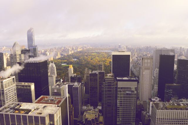 Skyline of New York City, showcasing tall skyscrapers with Central Park full of autumn foliage in the background. Can be used for travel promotions, urban living concepts, cityscape aesthetics, and real estate marketing.