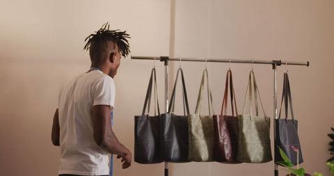 African American Craftsman Organizing Leather Bags