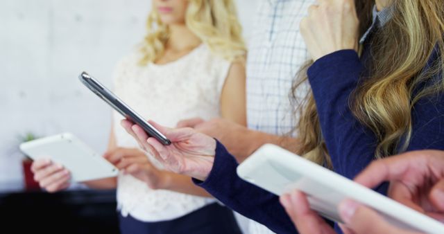 Group of People Using Smartphones and Tablets Indoors - Download Free Stock Images Pikwizard.com