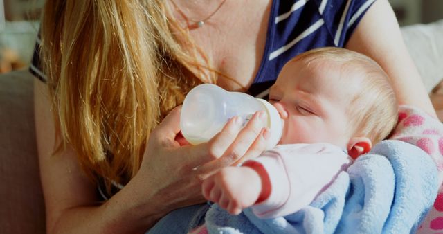 Mother Feeding Baby with Bottle in Cozy Home Setting - Download Free Stock Images Pikwizard.com