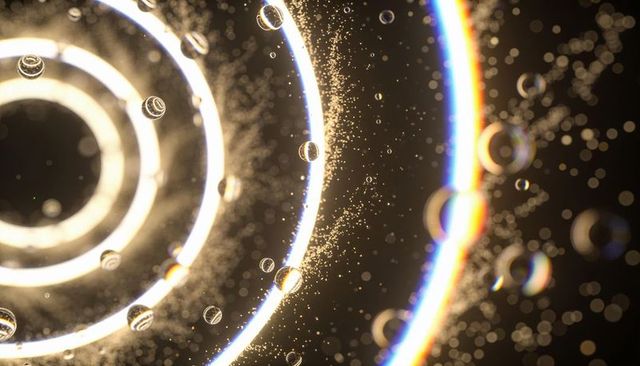 Concentric light rings with floating droplets and golden bokeh
