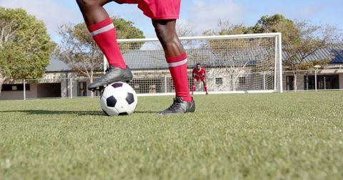 Soccer Players Practicing on Grass Field in Bright Daylight