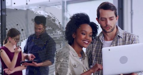 Team Collaborating with Technology in Modern Office Environment