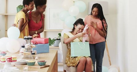 Friends Celebrating with Gifts and Desserts in Joyful Home Gathering