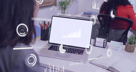 Analyzing real-time analytics on laptop with holographic hud in open office collaboration