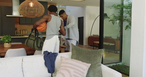 Friends preparing for basketball game in modern home interior