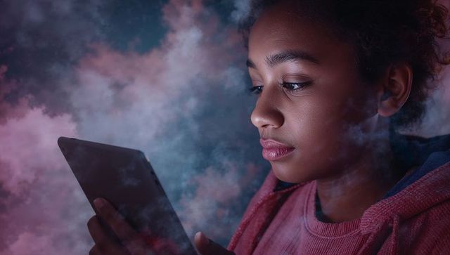 Teen Girl Engaged with Tablet in Mystical Misty Atmosphere