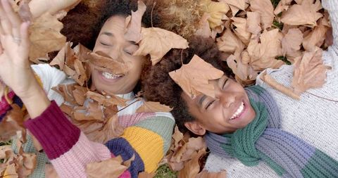 Joyful Mother and Son Playing in Fall Leaves Outdoors - Download Free Stock Images Pikwizard.com