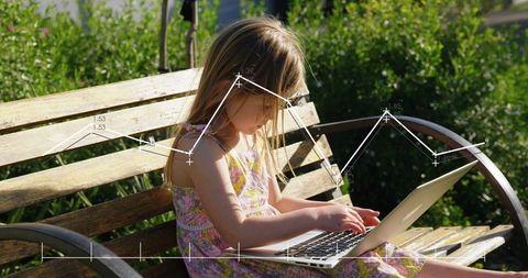 Young Girl Using Laptop with Data Graphics in Garden