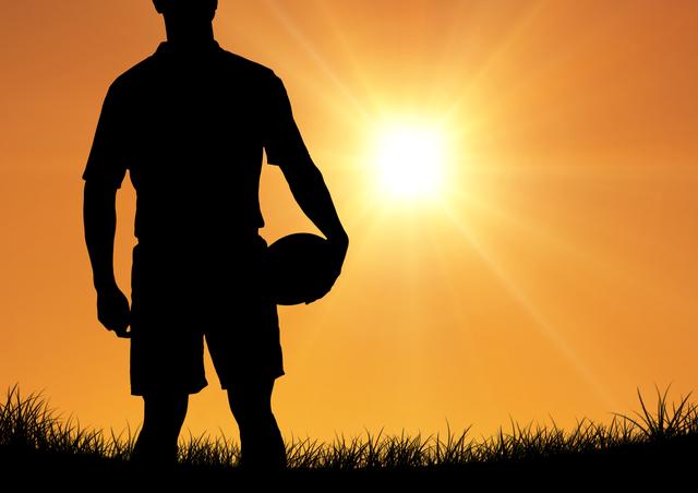 Depicts rugby player standing against vibrant sunset holding ball. Great for sports promotions, athletic training materials, motivation posters, summer outdoor event advertising.