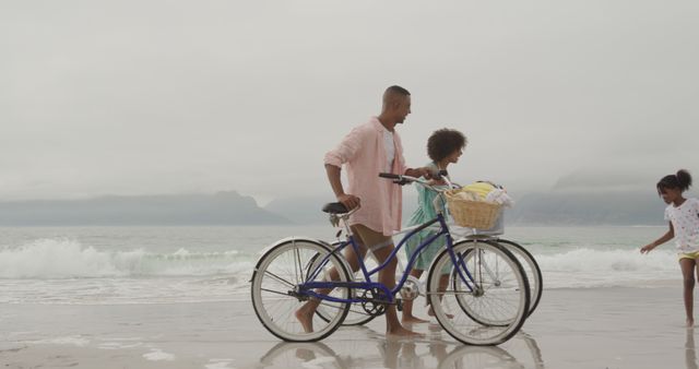 Young Family Enjoying Beach Day with Bicycles and Smiling Daughter - Download Free Stock Images Pikwizard.com