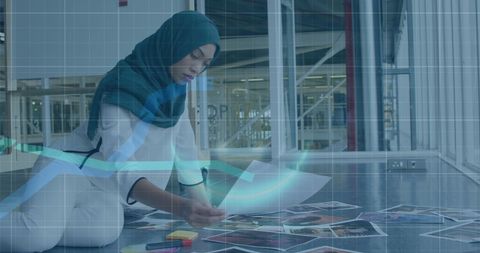 Businesswoman Analyzing Financial Trends with Graph Overlays