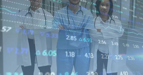 Standing medical team crossing arms with financial data overlay, doctors and nurses in clinic hall