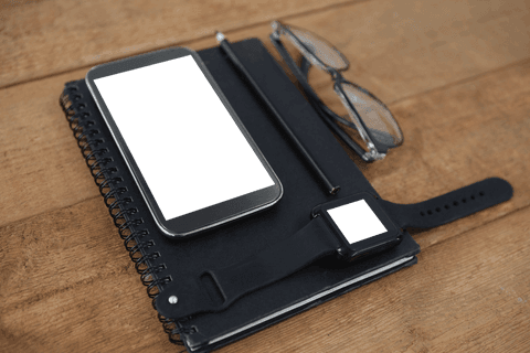 transparent phone screen with smartwatch office accessories on wooden desk - Download Free Stock Videos Pikwizard.com