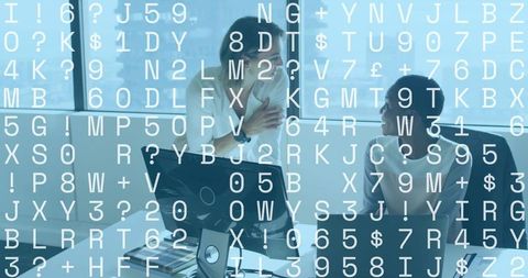 Female colleagues collaborating at desk with data overlay and laptop in modern office