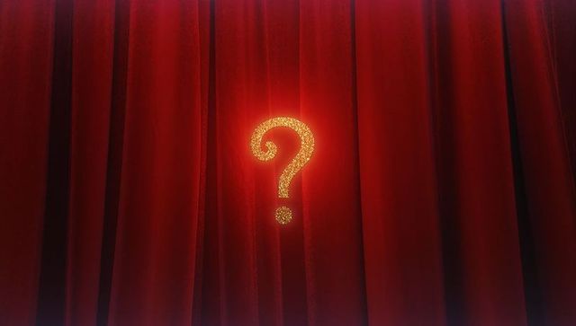 Shimmering question mark on luxurious red velvet curtain