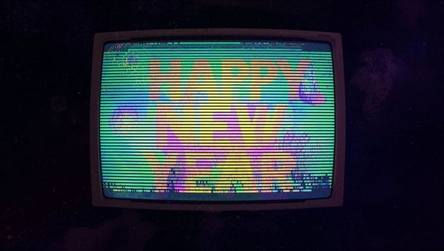 Retro CRT TV Displaying Happy New Year Neon Glitch With Scanlines, RGB Artifacts, Grain