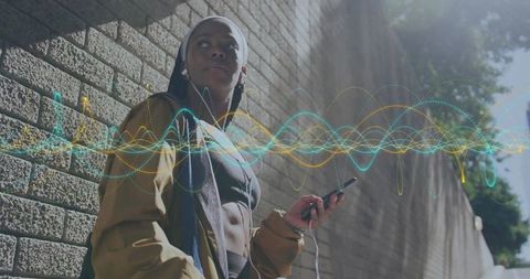 Athletic Woman with Smartphone Listening to Music on Street