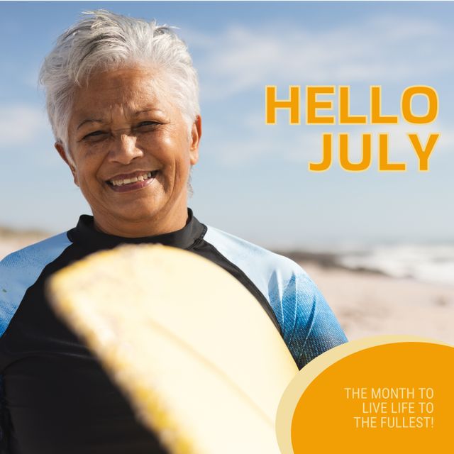 Composition of hello july text over biracial senior woman with surfboard on beach. July, summer, seaside and vacation concept digitally generated image.