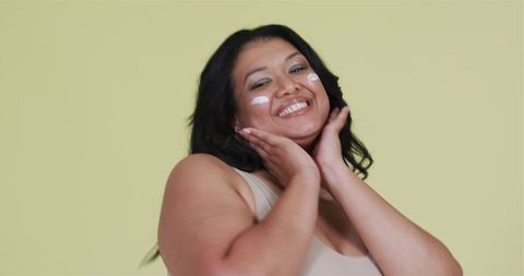 Confident woman celebrating natural skincare routine