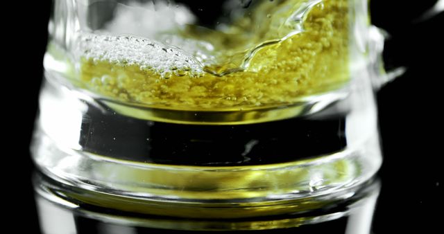 Close-up of Beer Splashing in Glass against Black Background - Download Free Stock Images Pikwizard.com