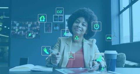 Woman in Office Analyzing Sustainable Business Metrics with Icons