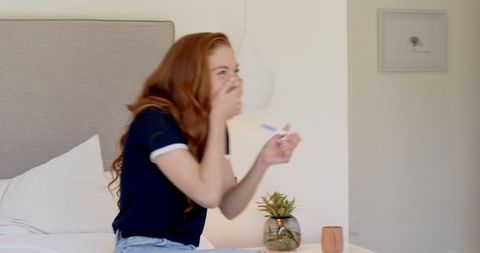 Woman excitedly discovers positive pregnancy test at home