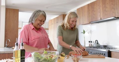 Diverse Friends Preparing Healthy Salad Together in Modern Kitchen