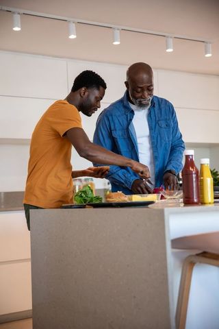 Father and Son Preparing Homemade Burgers at Kitchen Island
