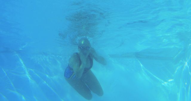 Person Underwater Swimming with Goggles in Blue Pool - Download Free Stock Images Pikwizard.com