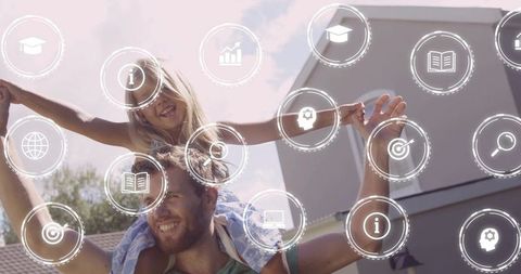 Father carrying daughter on shoulders in backyard with digital education icons overlay