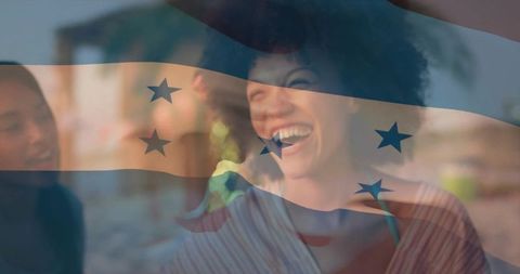 Laughing woman at beach with translucent flag overlay celebrating friendship and summer