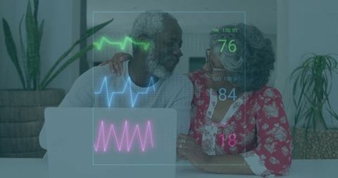 Senior Couple Using Laptop with Health Data Overlay in Living Room