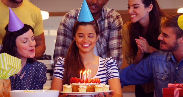 Joyful Friends Celebrating Woman's Birthday with Cake and Party Hats - Download Free Stock Images Pikwizard.com