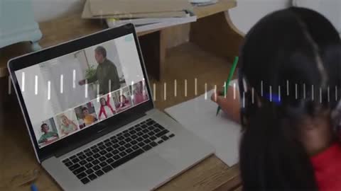 Child attending an online animation class, writing notes while watching a virtual lesson on a laptop from home. Ideal for highlighting online education, interactive e-learning environments, and remote classroom setups. Useful for articles on educational technology, home learning techniques, or creativity-focused academic courses.