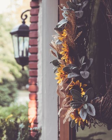 Rustic fall wreath design with sunflowers and lantern