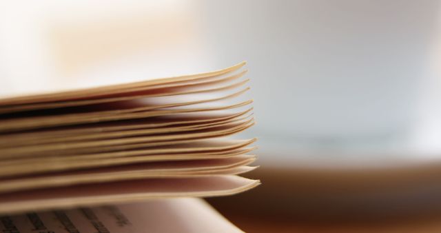 This stock image depicts a close-up view of a neatly stacked pile of documents, ideal for representing businesses, offices, and organizational themes. Perfect for use in blogs, presentations, and websites focusing on productivity, office environments, and administrative tasks.